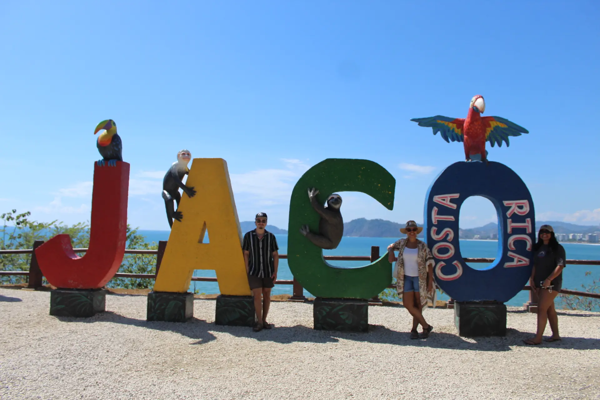 Family enjoying a trip in Jaco Costa Rica at the iconic Jaco sign