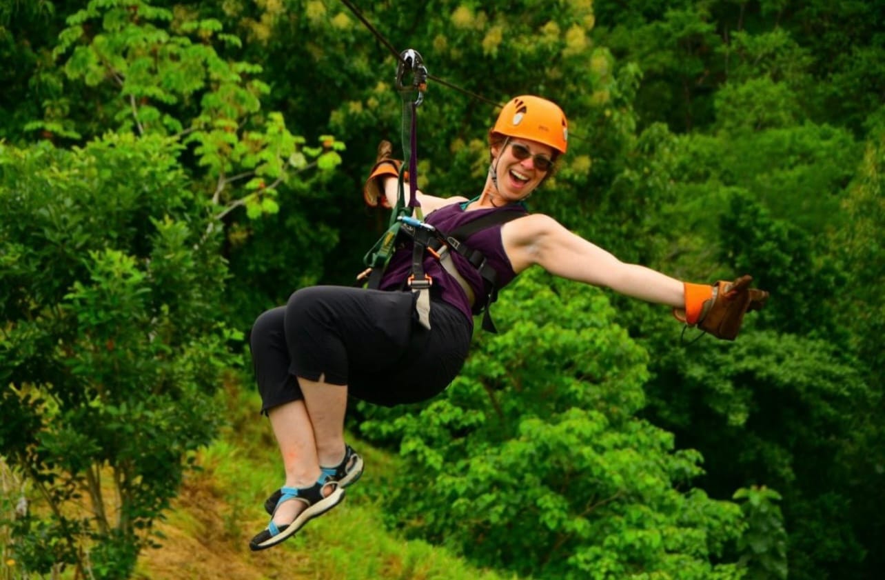 Traveler enjoying a zipline adventure through the Costa Rican rainforest near Jaco