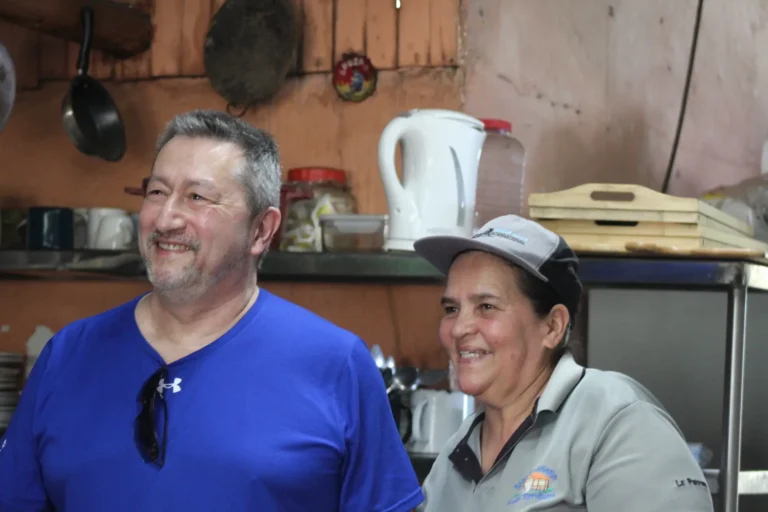 Guests smiling with Doña Marta at a mountain restaurant near Jaco Costa Rica