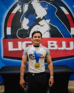 Jiu Jitsu athlete Carlos Mejia with gold medal after competition victory