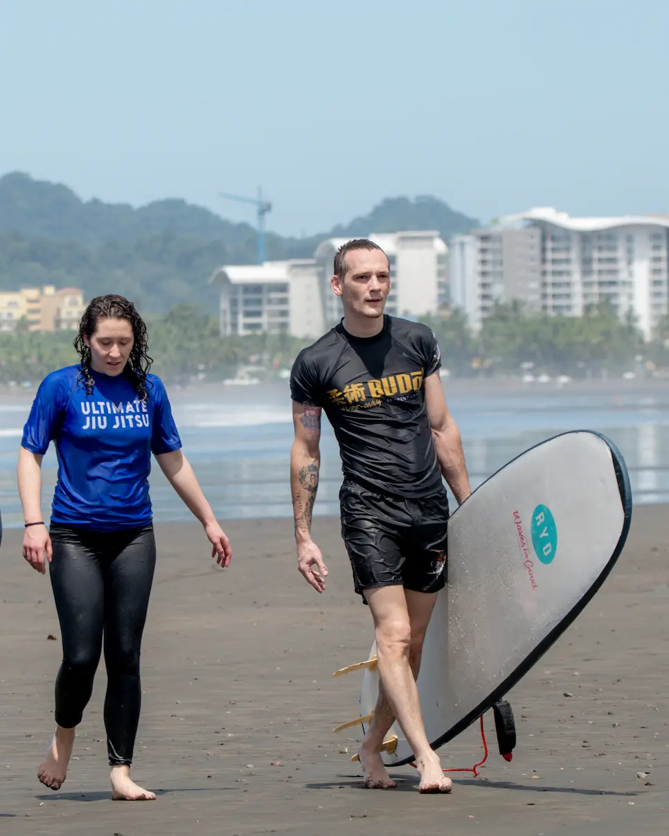 Jiu Jitsu retreat participants enjoying surfing at Jaco Beach, Costa Rica