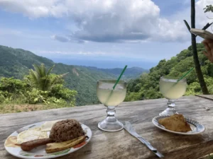 Costa Rican breakfast with gallo pinto and fresh juice enjoyed with mountain and ocean views in Jaco