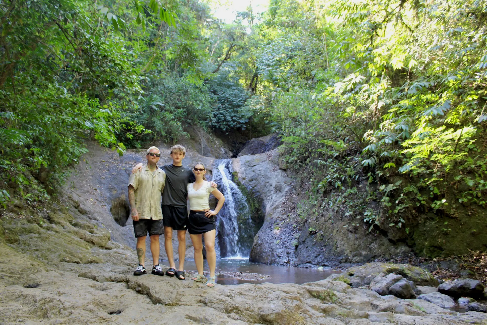 Family enjoying a waterfall in Jaco Costa Rica during a nature experience
