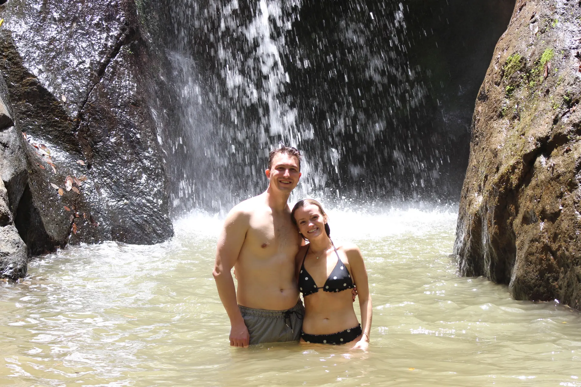 Couple enjoying a waterfall experience near Jaco Costa Rica during a romantic getaway