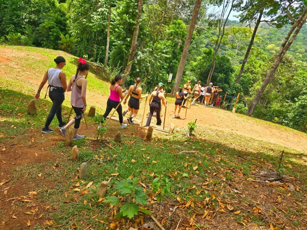 Group hiking toward Nauyaca Waterfalls through rainforest in Costa Rica