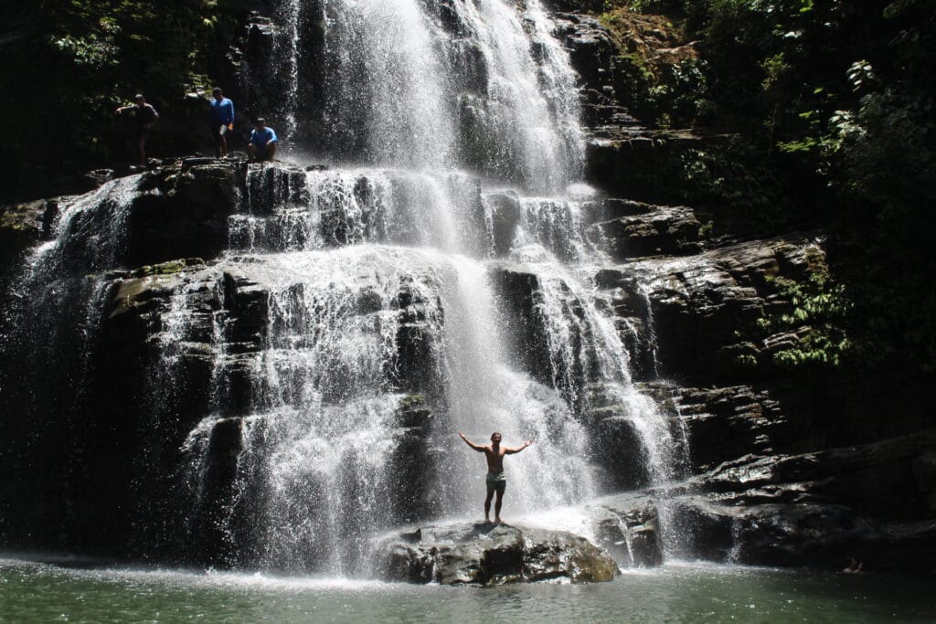 Traveler standing at Nauyaca Waterfalls during a Costa Rica tour