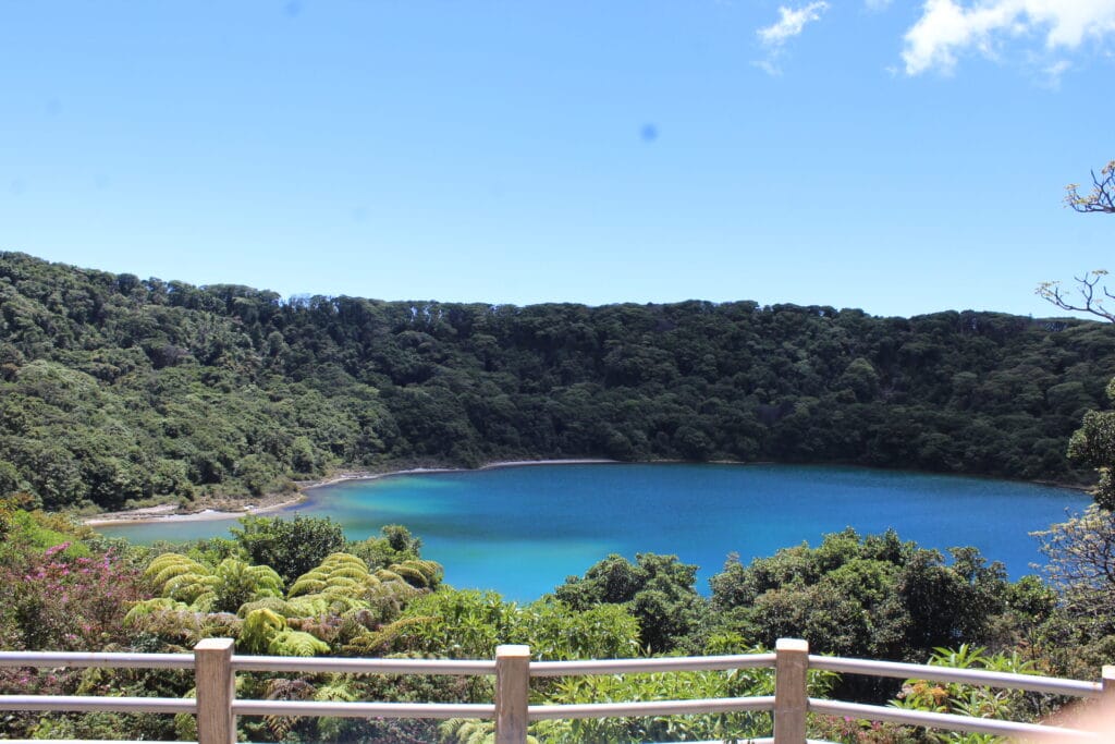 Botos lagoon inside Poas Volcano crater in Costa Rica surrounded by forest