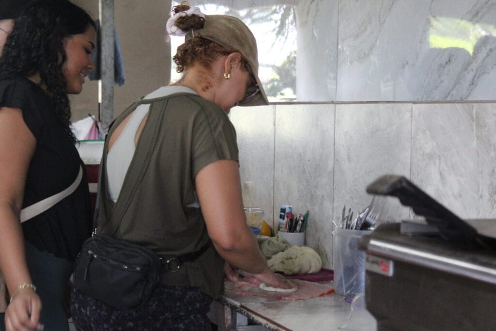 Visitors learning how to make traditional Costa Rican tortillas at Doña Marta’s restaurant near Jaco as part of a hands-on culinary experience.