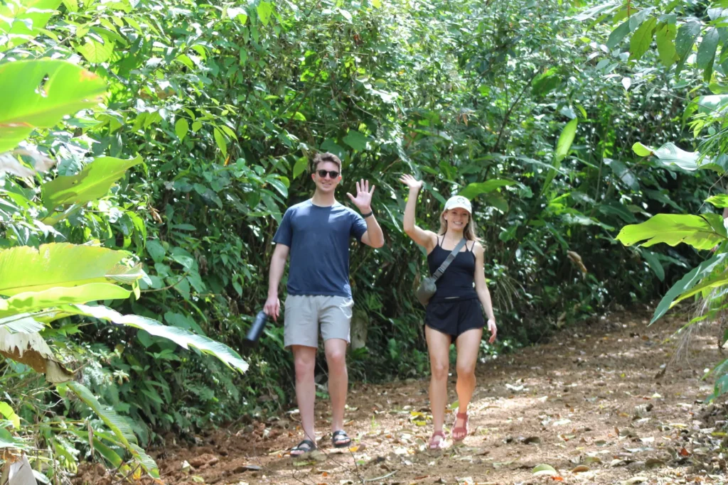 Couple walking through jungle during a Jaco waterfall tour in Costa Rica