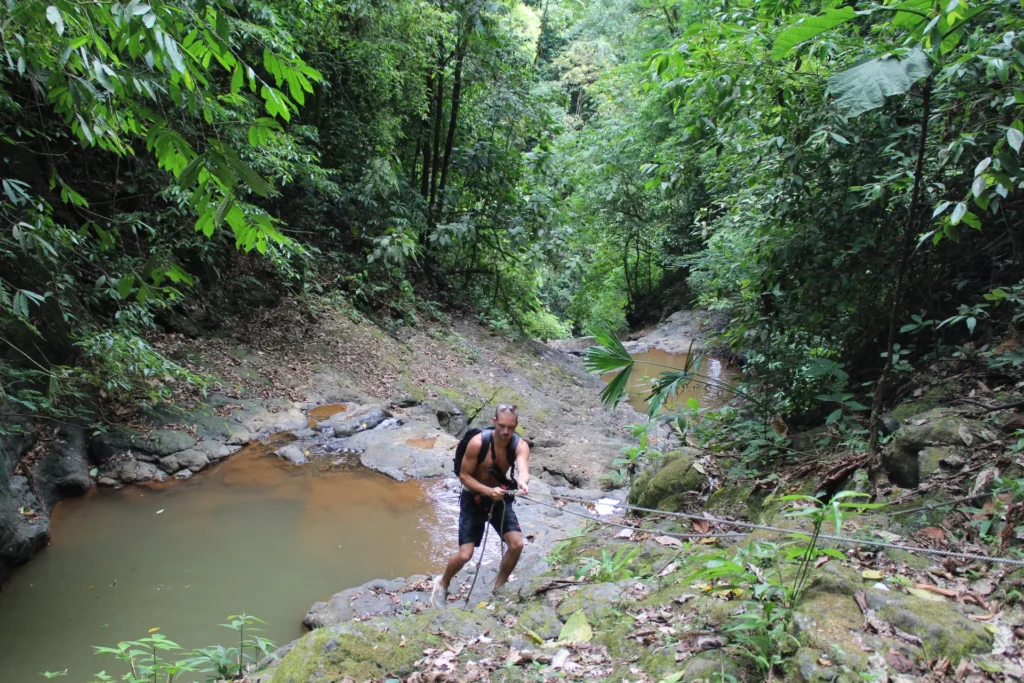 Traveler exploring a stream during a Jaco waterfall tour in Costa Rica