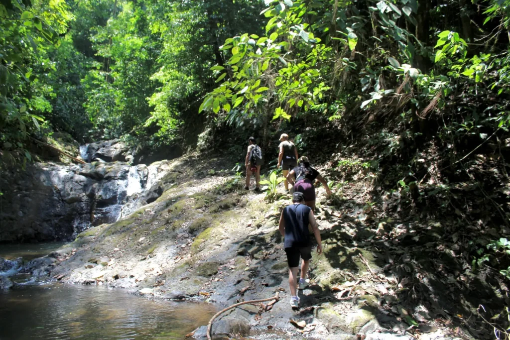 Travelers hiking along a waterfall trail near Jaco Costa Rica
