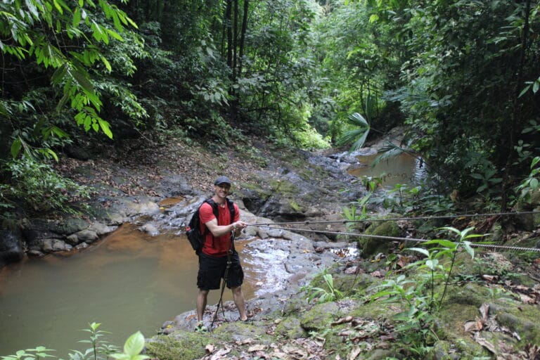 Couple posing beside a waterfall at Jaco Falls
