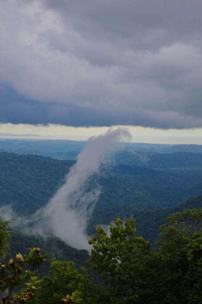 Rain clouds and mist over the lush rainforest mountains near Jaco during Costa Rica's green season