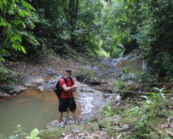 Couple posing beside a waterfall at Jaco Falls