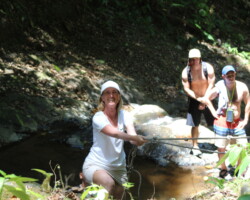Group crossing a stream on the way to Jaco Falls