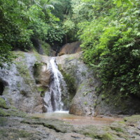 Hidden waterfall near Jaco Costa Rica surrounded by rainforest
