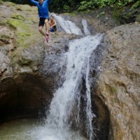 Traveler enjoying a natural waterfall near Jaco Costa Rica