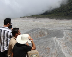 Visitors overlooking the crater at Poas Volcano National Park in Costa Rica