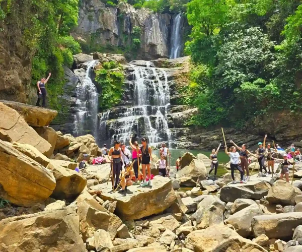 nauyaca falls with people ejoying the tour