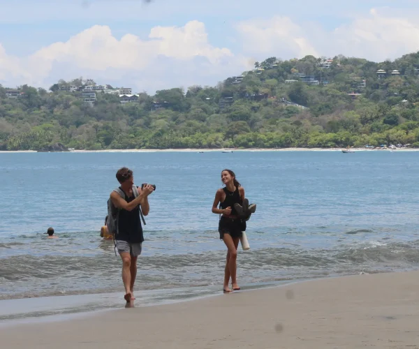 Travelers walking on the beach in Manuel Antonio National Park Costa Rica
