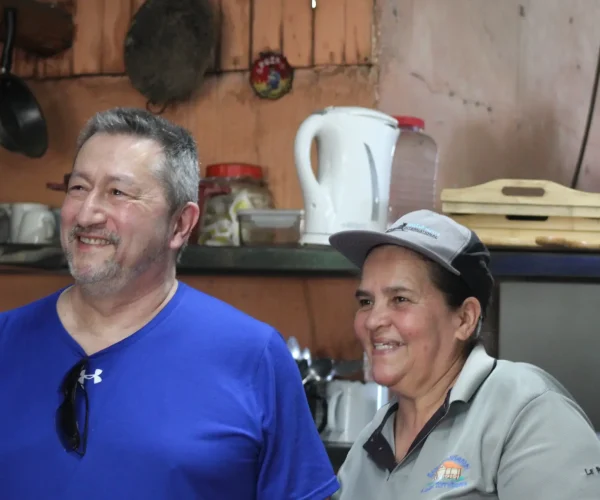 Guests smiling with Doña Marta at a mountain restaurant near Jaco Costa Rica