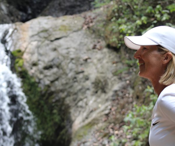 Traveler enjoying a waterfall up close during a Jaco Waterfalls Tour in Costa Rica